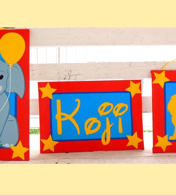 A painting of an elephant and a painting of a child's name